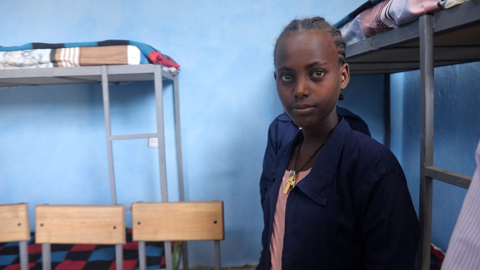 A girl in her dormitory, where 180 students now live safely