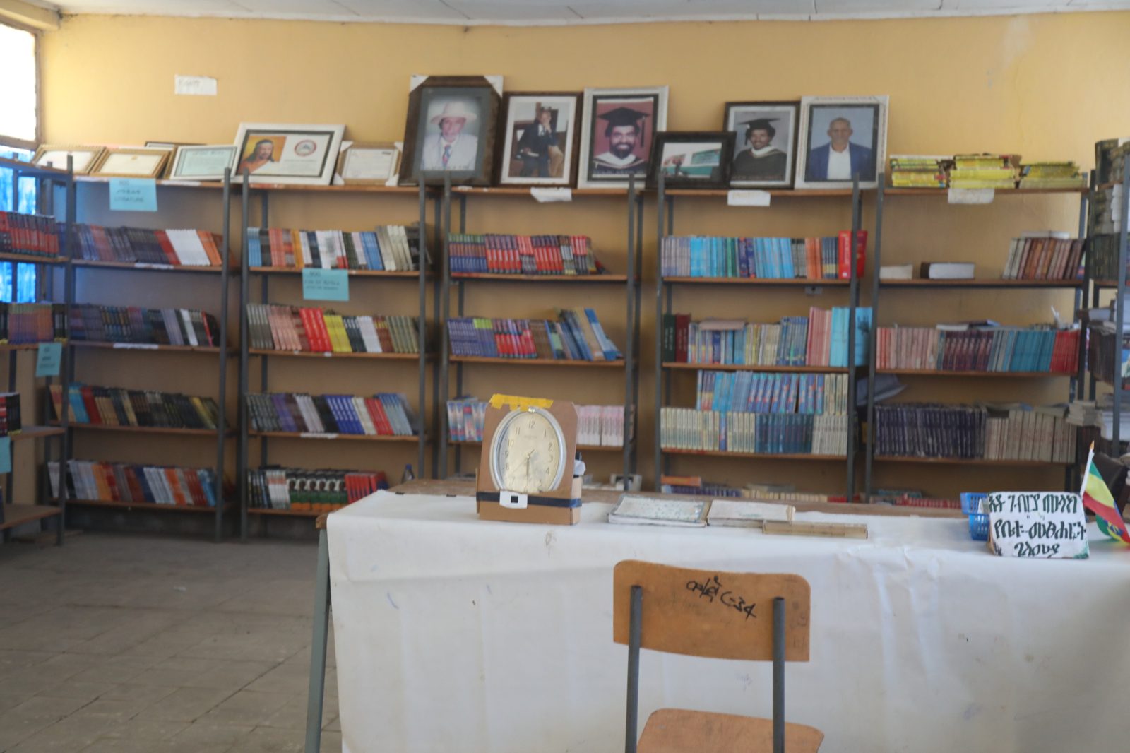 The school library, with framed portraits of the founder above the shelves