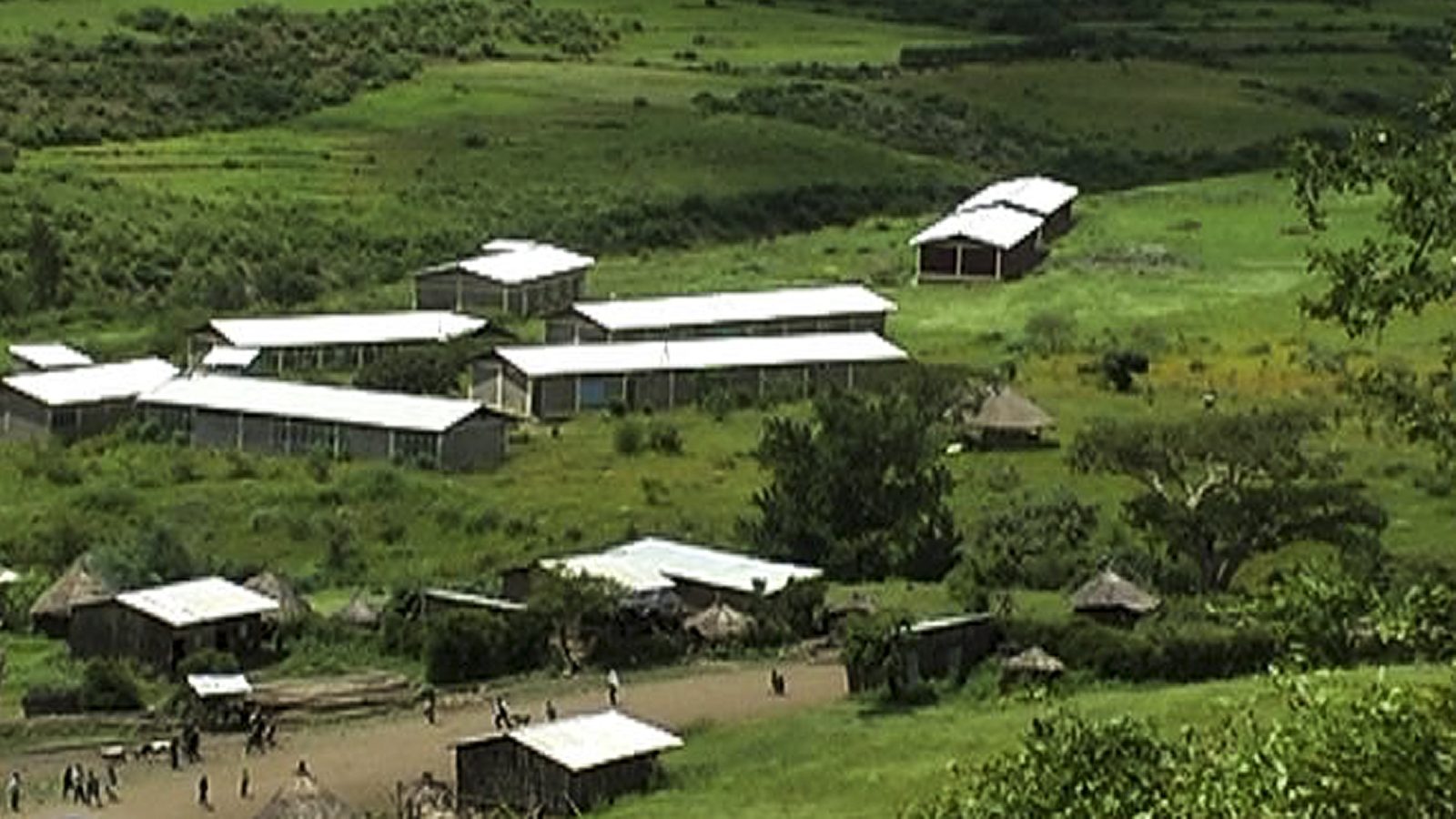The school buildings nestled in the green highland valley